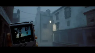 Hands holding a small screen device on a Townfall street