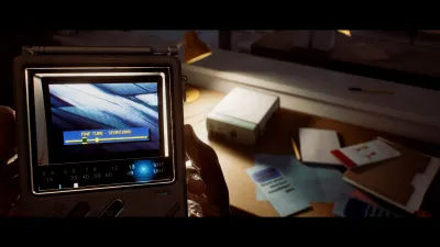 Handheld device showing a screen beside documents on a Townfall desk