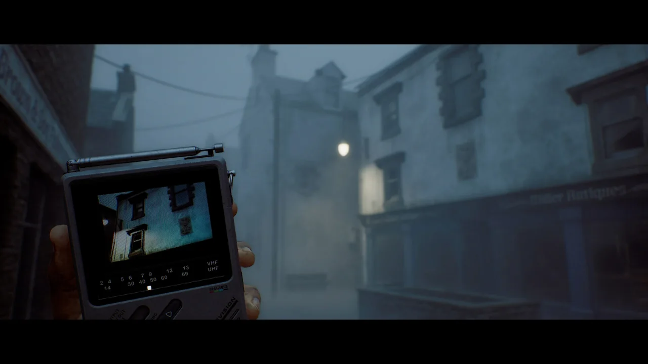 Official SILENT HILL: Townfall screenshot: the CRTV pocket television held up in a fog-covered St. Amelia street